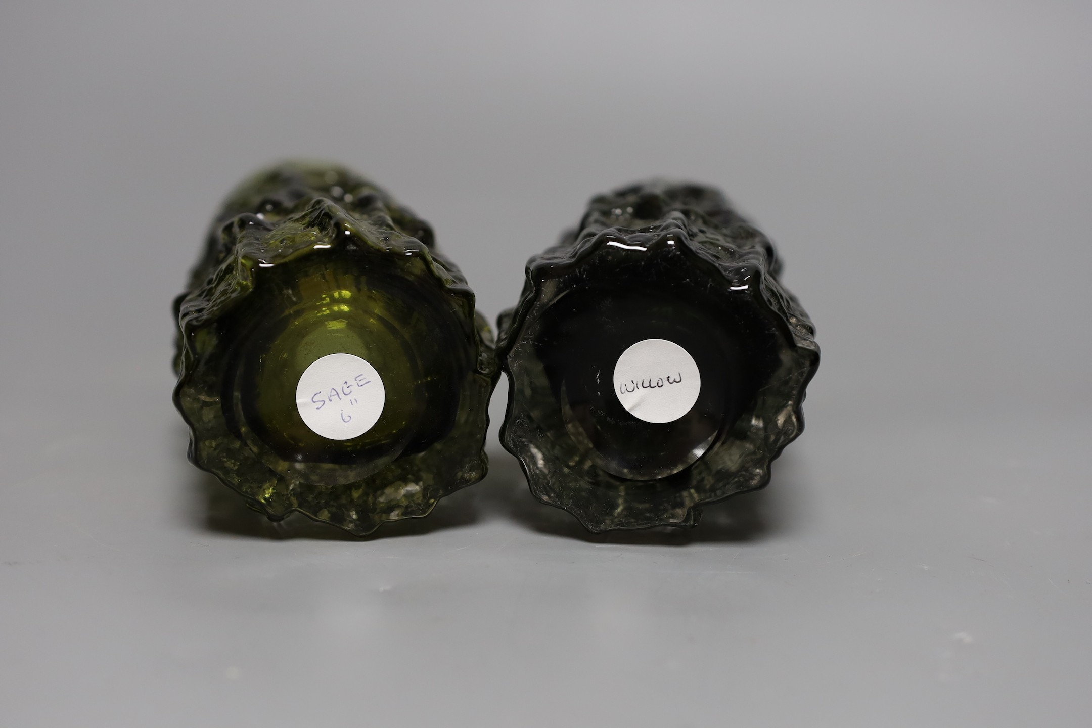 Two Whitefriars 'bark' cylinder vases, model 9689 designed by Geoffrey Baxter in ‘sage’ and 'willow' glass, each 15cm high.